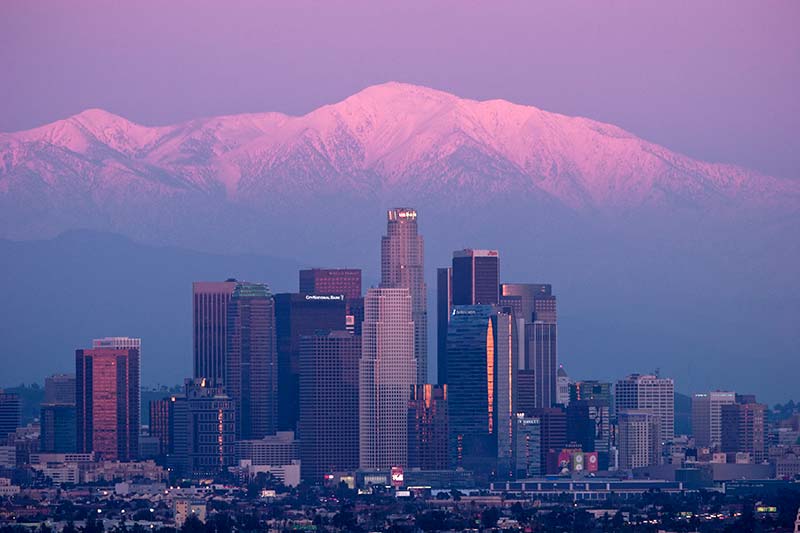 L.A. Skyline with Sunset Alpenglow on Snowy Mount Baldy Peak in Background, Southern California